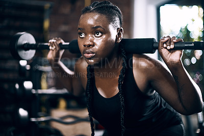 Buy stock photo Full length shot of an attractive young female athlete lifting weights in the gym