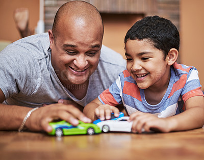 Buy stock photo Father, son and playing with toy car for love, relationship in home as family in bonding. Man, boy and fun for activity in together in learning, childhood development and growth on weekend in support