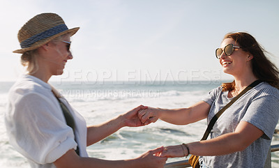 Buy stock photo Cropped shot of a happy young couple dancing and enjoying themselves outdoors near the beach