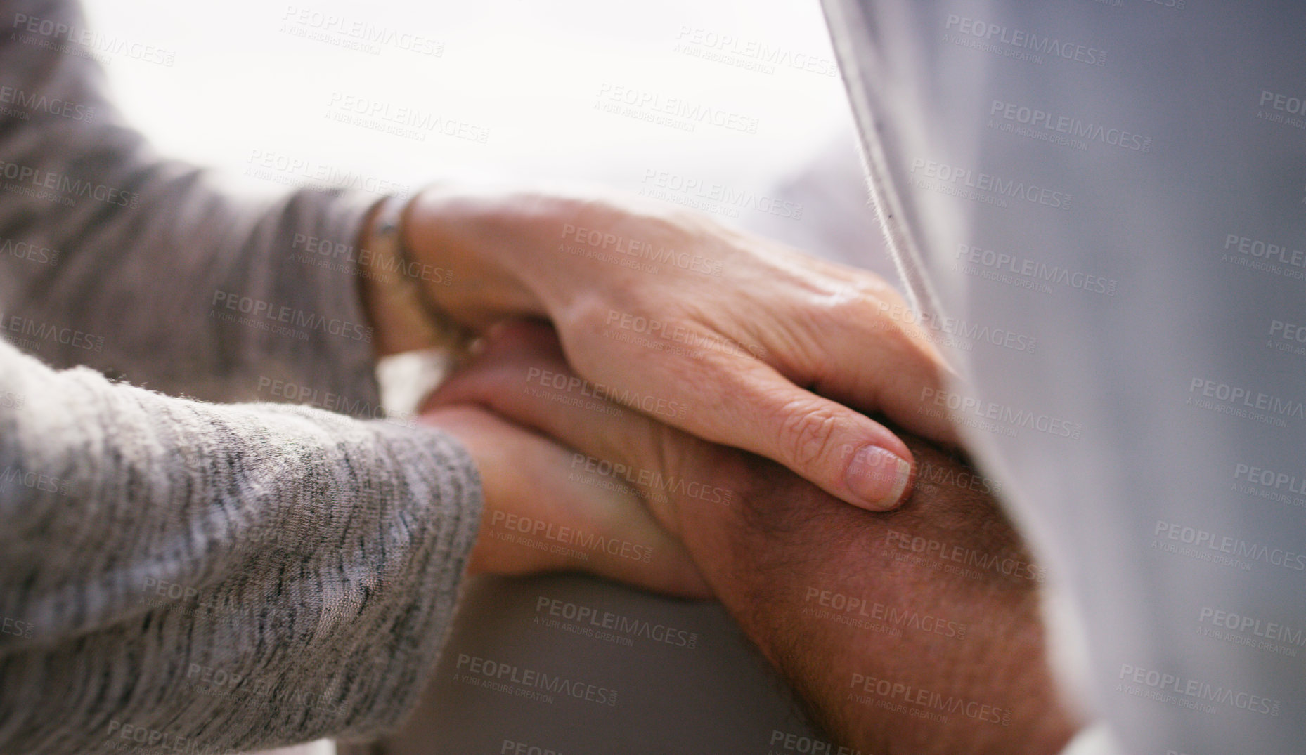 Buy stock photo Cropped shot of an unrecognizable senior couple holding hands intimately while sitting at the beach