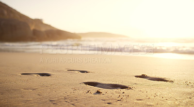 Buy stock photo Still life shot of footsteps on the beach sand at sunset