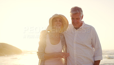 Buy stock photo Cropped shot of an affectionate senior couple enjoying the beach at sunset
