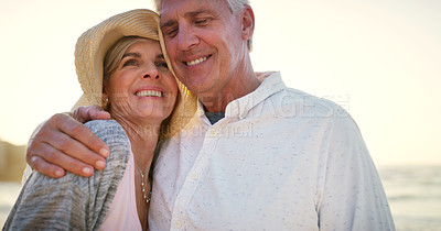 Buy stock photo Cropped shot of an affectionate senior couple embracing each other at the beach at sunset