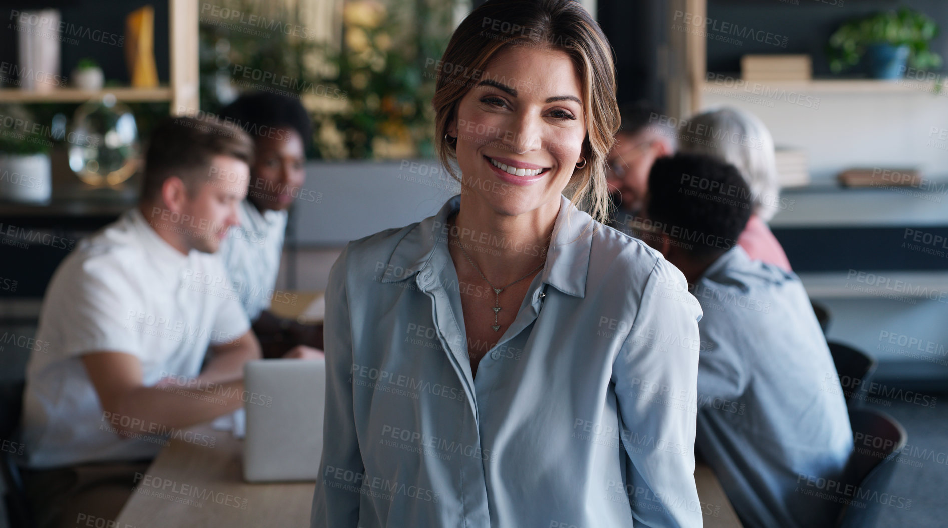 Buy stock photo Portrait of a confident young businesswoman in in the office boardroom with her colleagues in the background