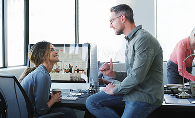 Buy stock photo Shot of a businessman and businesswoman having a discussion and using a computer together in a modern office