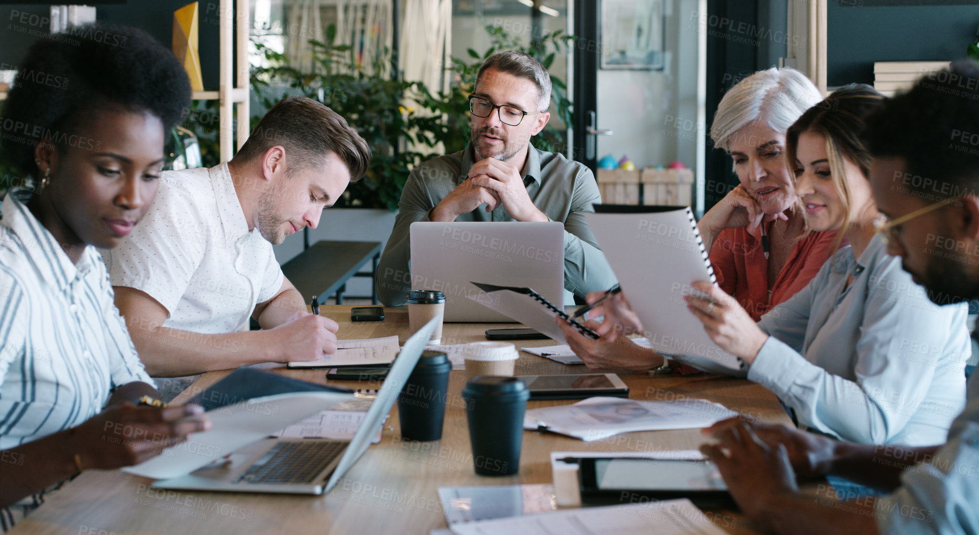 Buy stock photo Shot of a group of businesspeople having a meeting in a modern office