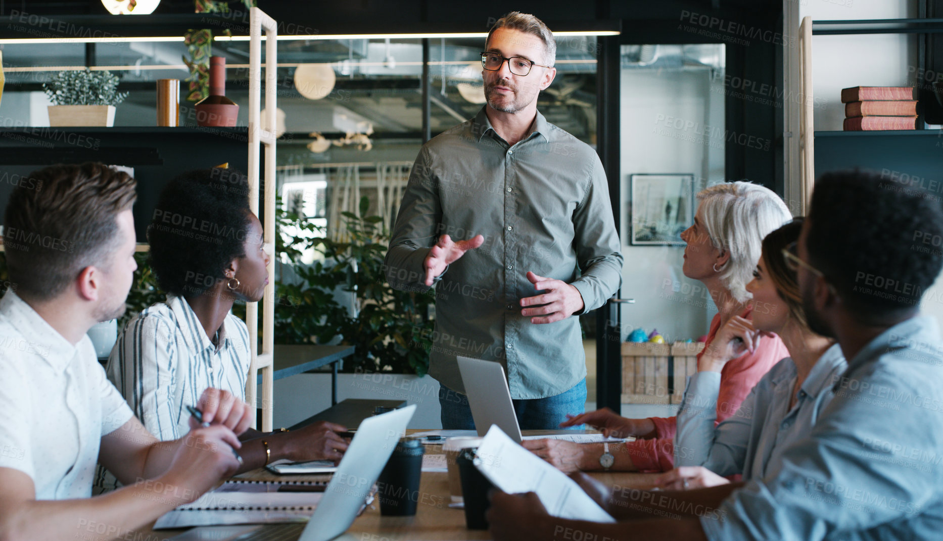 Buy stock photo Shot of a group of businesspeople having a meeting in a modern office