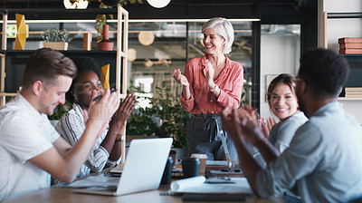 Buy stock photo Shot of a group of businesspeople clapping during a meeting in a modern office