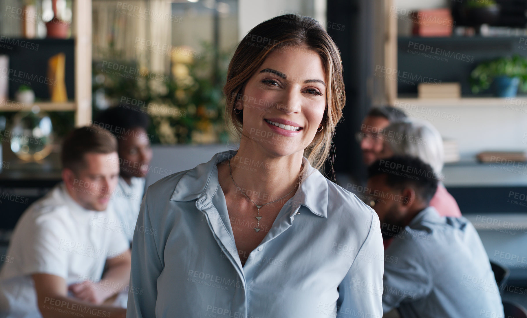 Buy stock photo Portrait of a confident young businesswoman in in the office boardroom with her colleagues in the background
