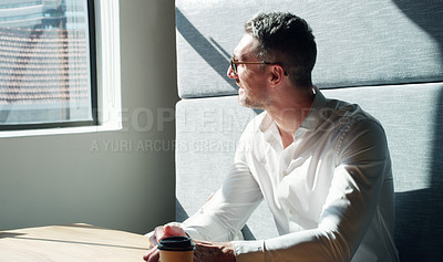 Buy stock photo Shot of a mature businessman looking thoughtfully out of a window in a modern office