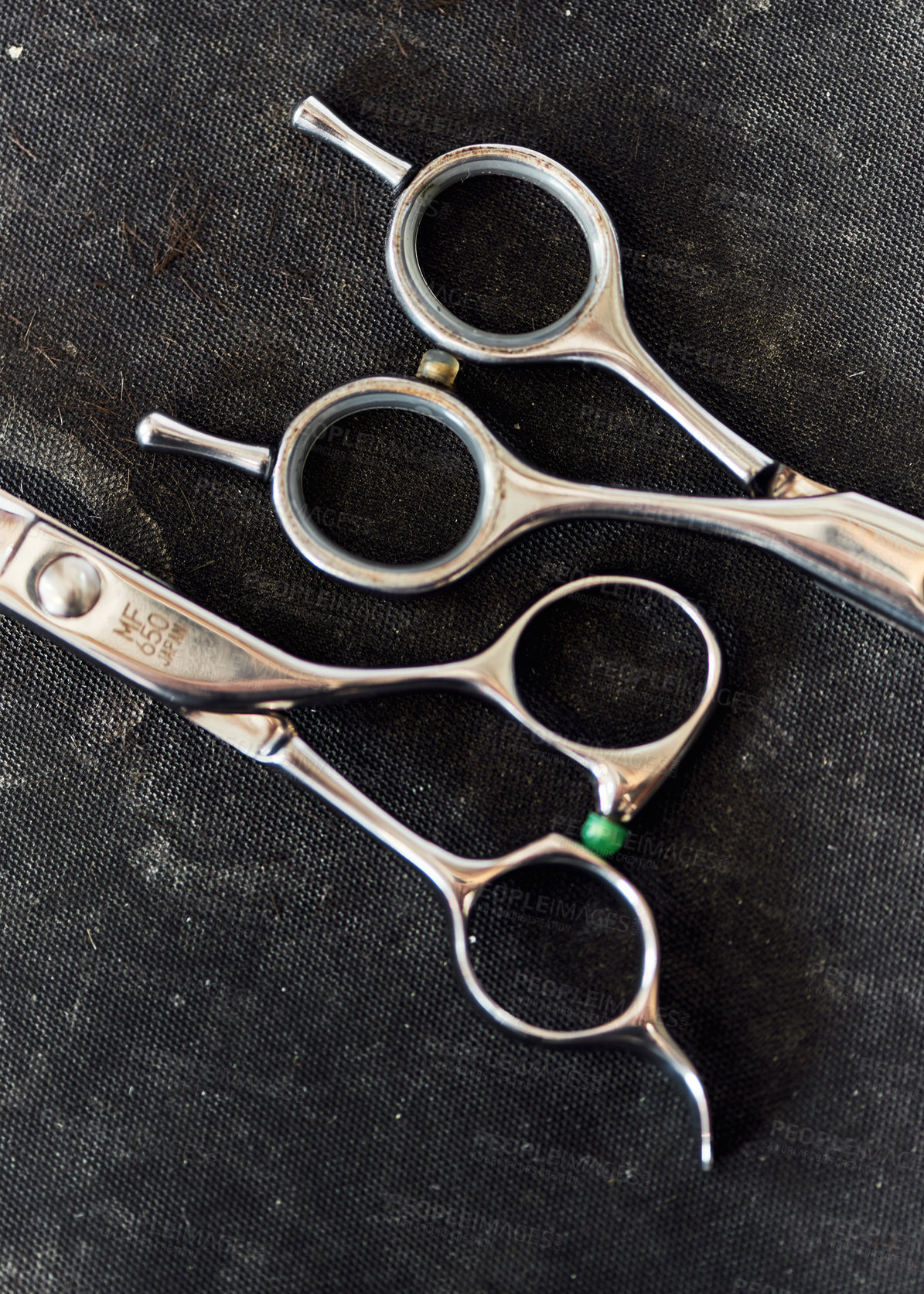 Buy stock photo Still life shot of a set of shear scissors used for trimming hair inside a barbershop