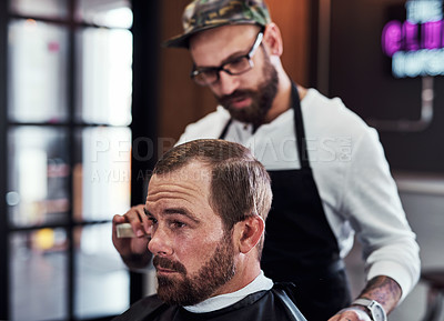 Buy stock photo Cropped shot of a handsome mature man getting a haircut at a barbershop