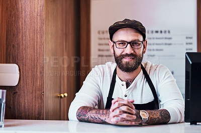 Buy stock photo Portrait of a handsome young barber posing inside his barbershop