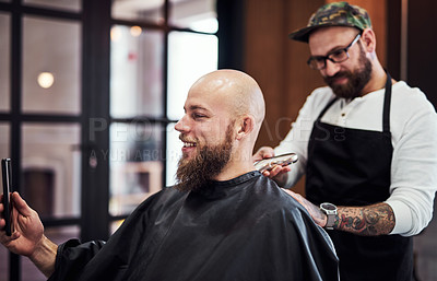 Buy stock photo Cropped shot of a handsome young man getting a haircut at a barbershop
