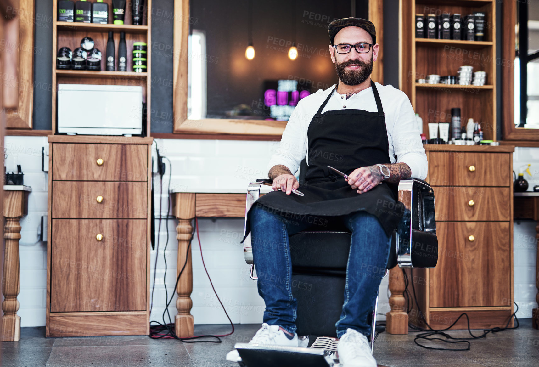 Buy stock photo Barber, chair and portrait of man with tools for hair grooming, wellness and beard service. Professional, small business and person in barbershop, salon and parlor for haircare, career and styling