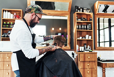 Buy stock photo Cut, child client and barber in barbershop with clippers for trimming, makeover or grooming service. Hairstyle, customer and hairstylist for haircut, hair care or hairdresser treatment in salon