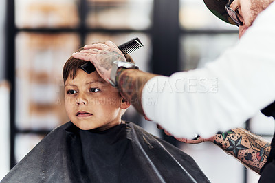 Buy stock photo Cropped shot an adorable little boy getting a haircut at the barbershop