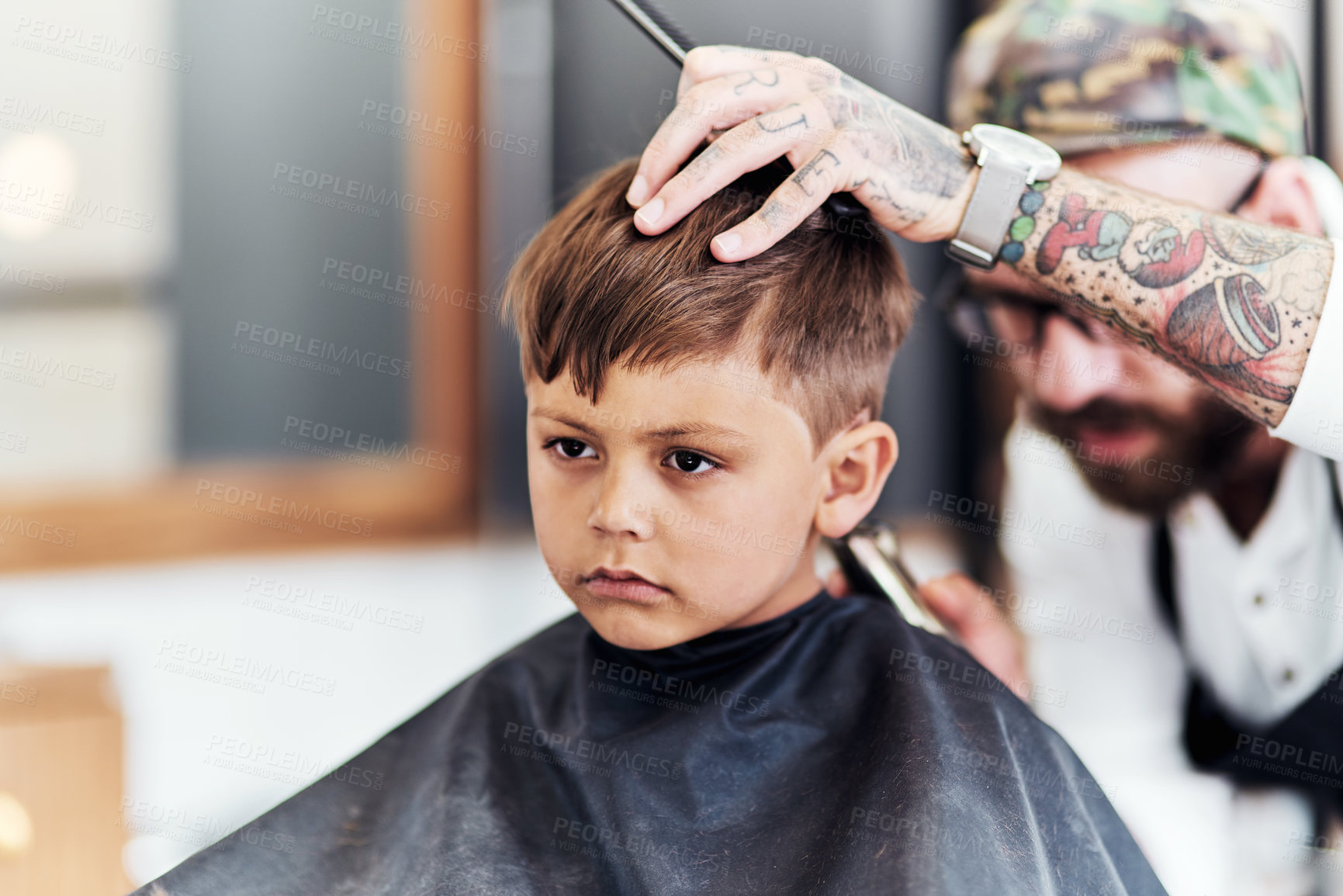 Buy stock photo Cropped shot an adorable little boy getting a haircut at the barbershop