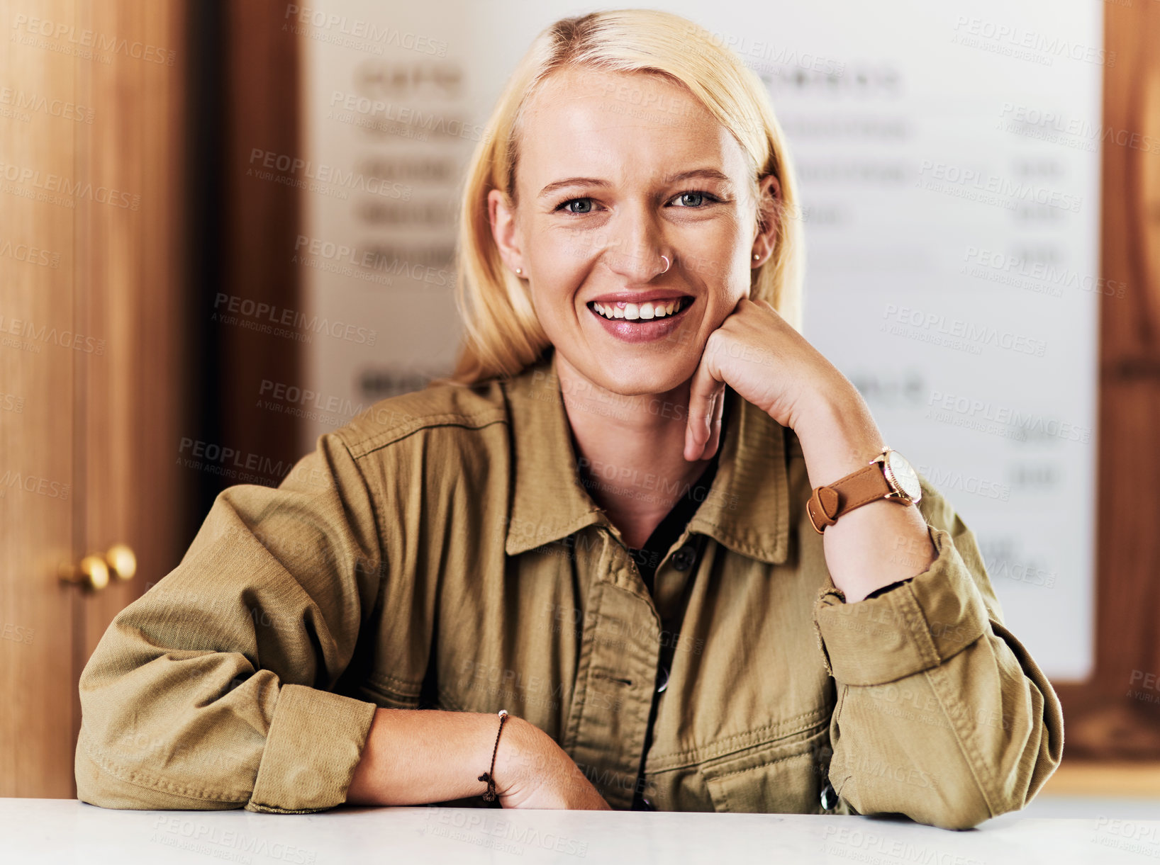 Buy stock photo Portrait of an attractive young hairdresser working at the reception area of her salon