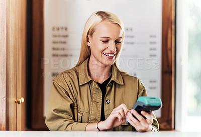 Buy stock photo Cropped shot of an attractive young hairdresser using a card machine inside her salon