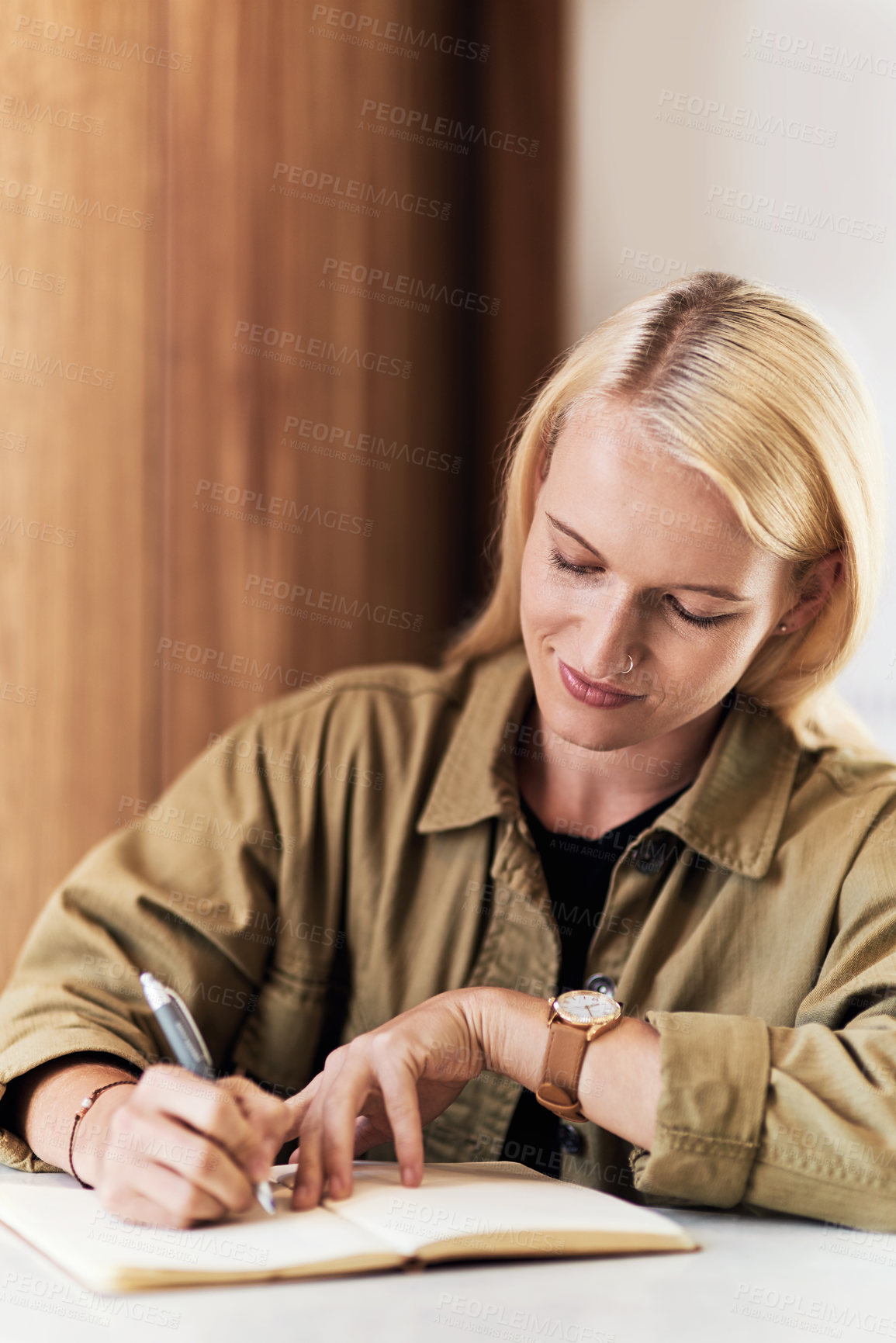 Buy stock photo Portrait of an attractive young hairdresser working at the reception area of her salon