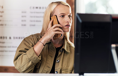 Buy stock photo Cropped shot of an attractive young hairdresser making a phone call and reservations inside her salon