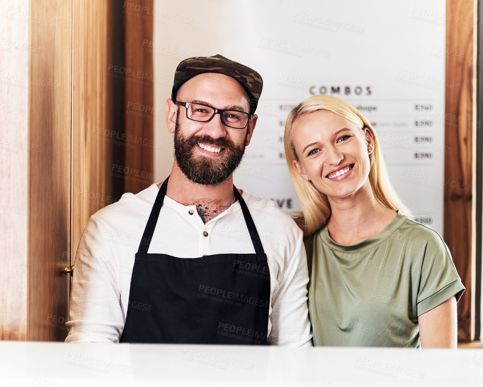 Buy stock photo Portrait of a happy young barber and hairdresser posing together inside their salon