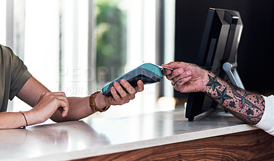 Buy stock photo Cropped shot of an unrecognizable hairdresser using a credit card machine to action a payment inside a salon