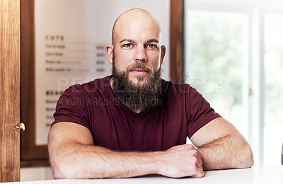 Buy stock photo Portrait of a handsome young barber working at the reception area of his barbershop