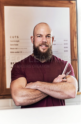 Buy stock photo Portrait of a handsome young  barber holding a hair comb and a pair of scissors inside his barbershop