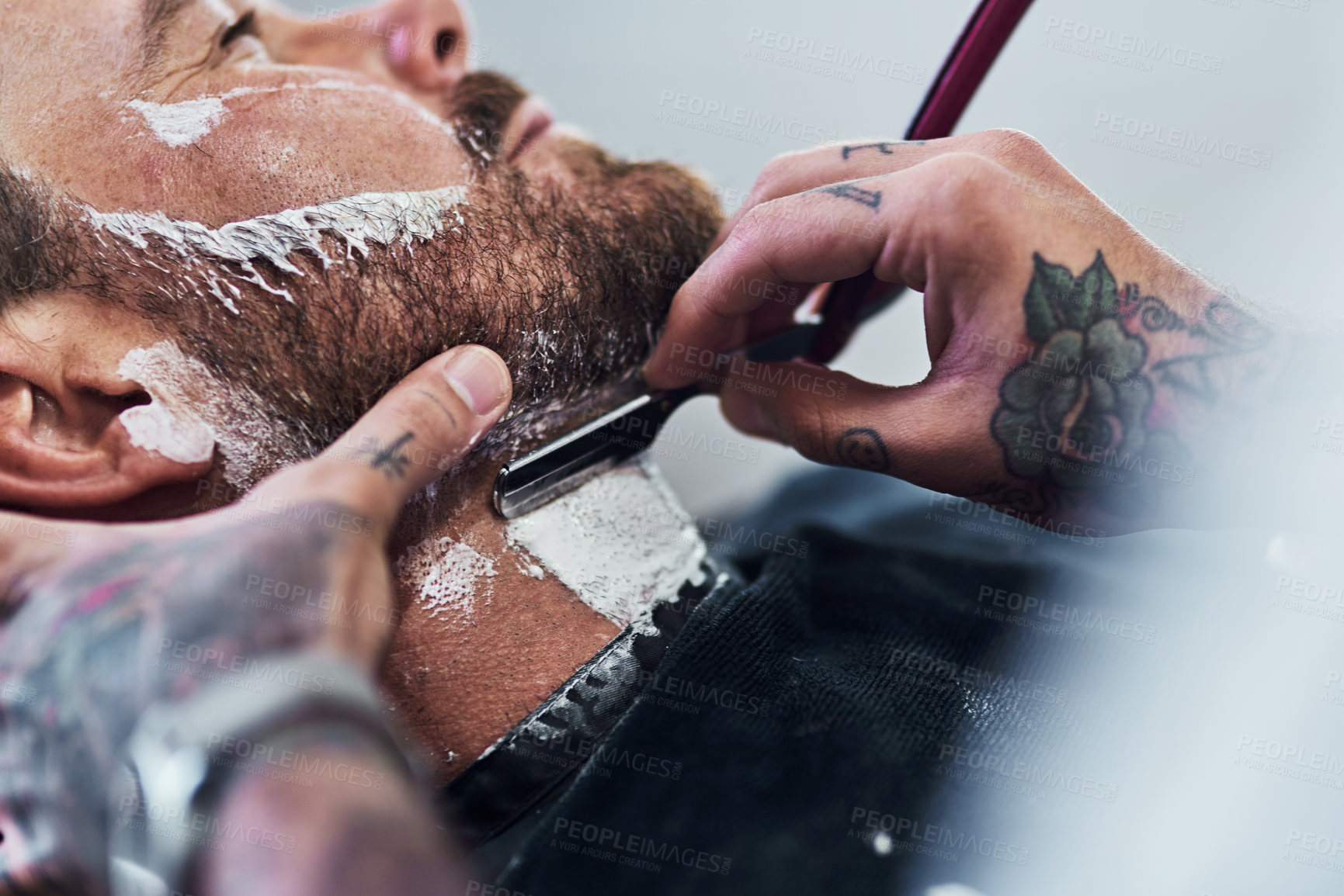 Buy stock photo Cropped shot of an unrecognizable man getting his beard trimmed and lined up at a barbershop