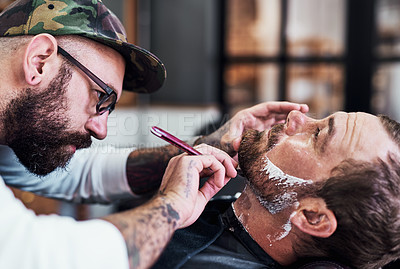 Buy stock photo Cropped shot of a handsome mature man getting his beard trimmed and lined up at a barbershop