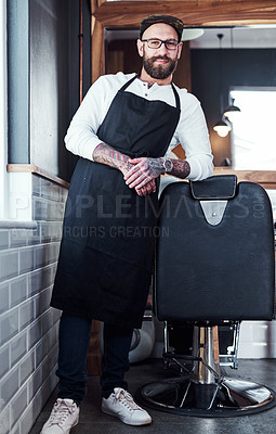 Buy stock photo Full length shot of a handsome young barber posing with his arms folded inside a barbershop