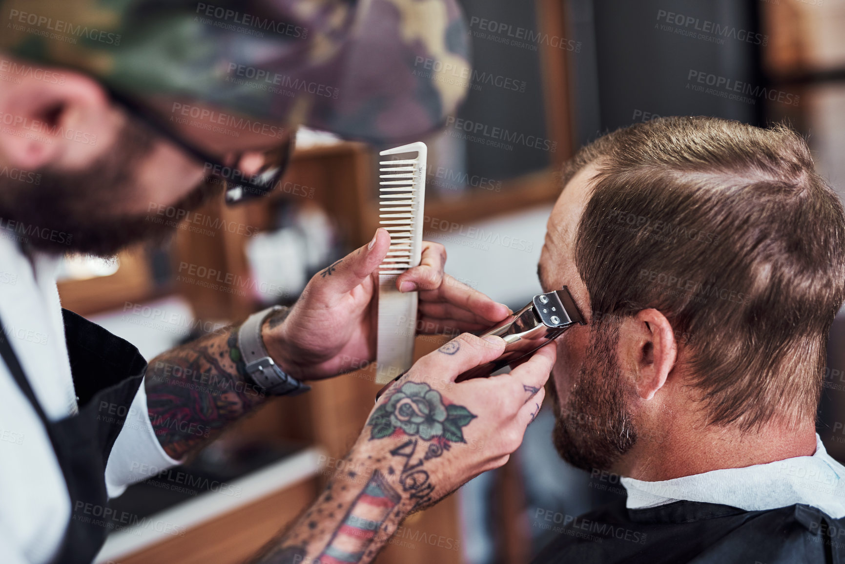 Buy stock photo Cropped shot of a handsome mature man getting a haircut at a barbershop