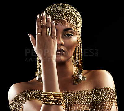 Buy stock photo African woman, portrait and gold jewelry with beauty and cosmetics in a studio. Isolated, black background and young female queen with crown, Egypt fashion and style with hand over face