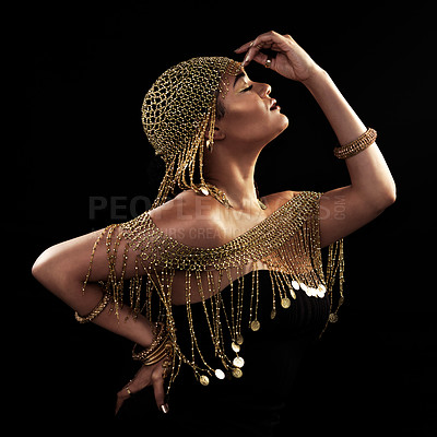 Buy stock photo Cropped shot of an attractive and elegantly dressed young woman posing against a dark background