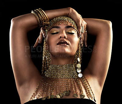 Buy stock photo Creative, beauty and woman with gold jewelry in studio, makeup or necklace with pride. Female person, culture and egyptian accessories with pose, cosplay and royal aesthetic on dark background