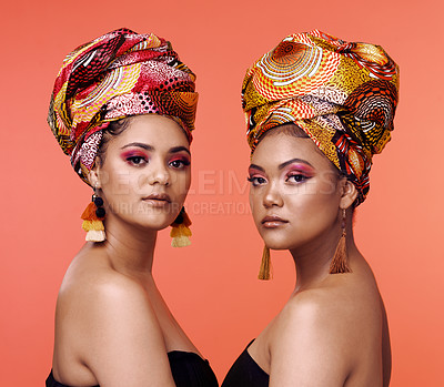 Buy stock photo African fashion, beauty and portrait of women on orange background with cosmetics, makeup and accessories. Glamour, studio and face of female people with exotic jewelry, traditional style and luxury