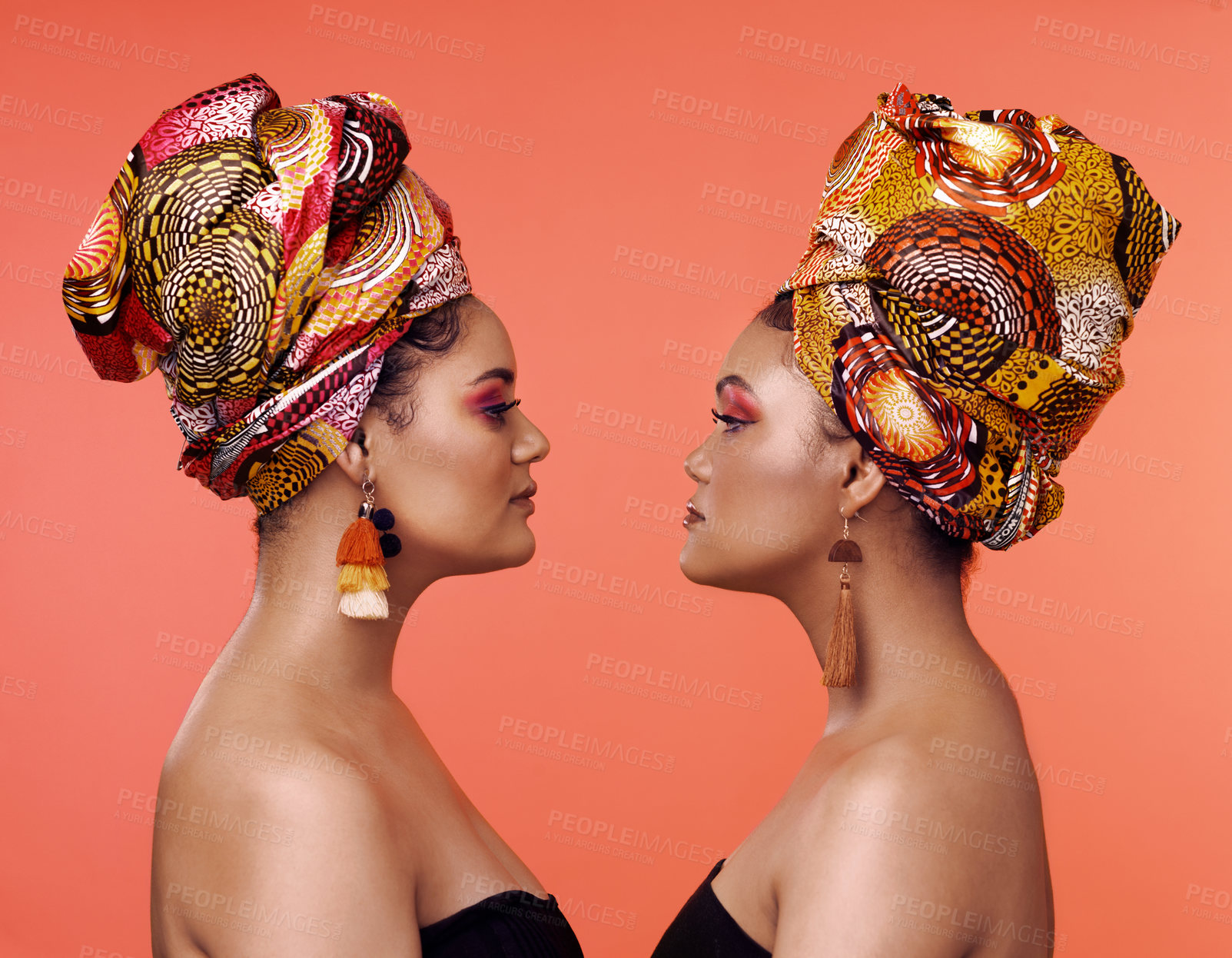 Buy stock photo African fashion, friends and profile of women on orange background with cosmetics, makeup and accessories. Glamour, beauty and face of female people with exotic jewelry, luxury style and head scarf