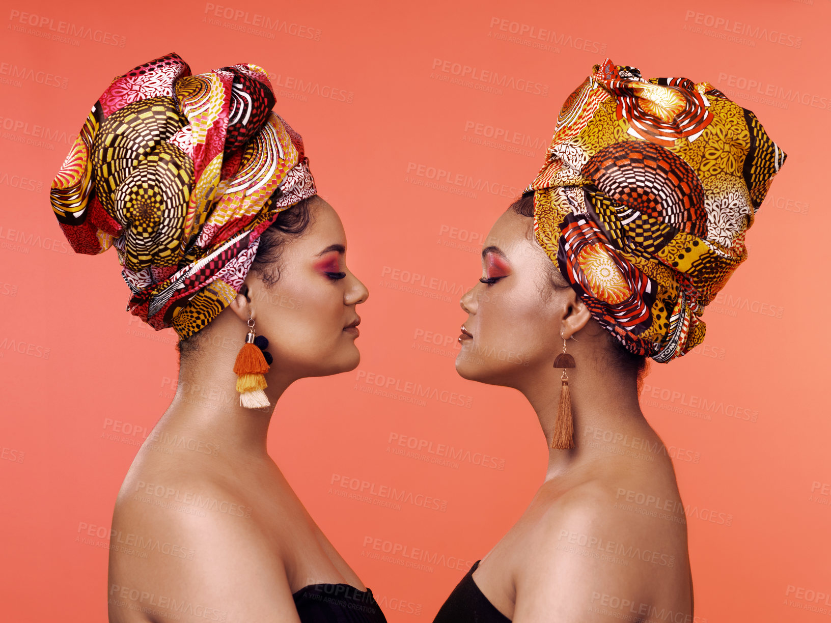 Buy stock photo African fashion, beauty and profile of women on orange background with cosmetics, makeup and accessories. Glamour, luxury and female people with exotic jewelry, traditional style and scarf in studio