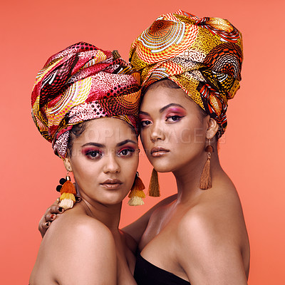 Buy stock photo African fashion, makeup and portrait of women on orange background for cosmetics, beauty and accessory. Glamour, designer and face of female people in exotic jewelry, luxury style and scarf in studio