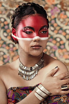 Buy stock photo Culture, paint and girl in traditional, clothes or attire, pride and serious with respect for religion. Pattern, background and art on face, indigenous and person with makeup, red and color for tribe