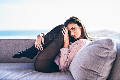 Buy stock photo Full length shot of a young woman posing provocatively on a sofa