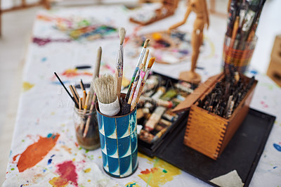 Buy stock photo Still life shot of paintbrushes lying on the floor in a art studio