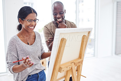 Buy stock photo Woman, happy and instructor in studio as art creative for painting, inspiration and talent workshop by easel. Artist, laugh and advice with mentor by canvas for drawing, learning or idea in atelier