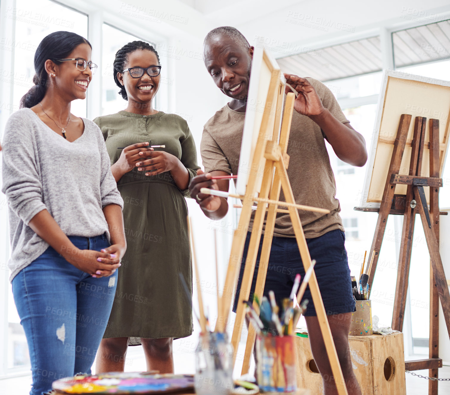 Buy stock photo Shot of a group of people discussing something in a art class