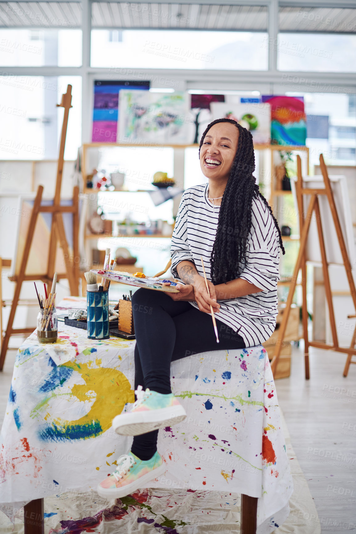 Buy stock photo Shot of a beautiful young woman smiling at the camera in a art studio