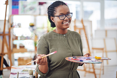 Buy stock photo Cropped shot of a young woman holding an artist's palette in a art studio