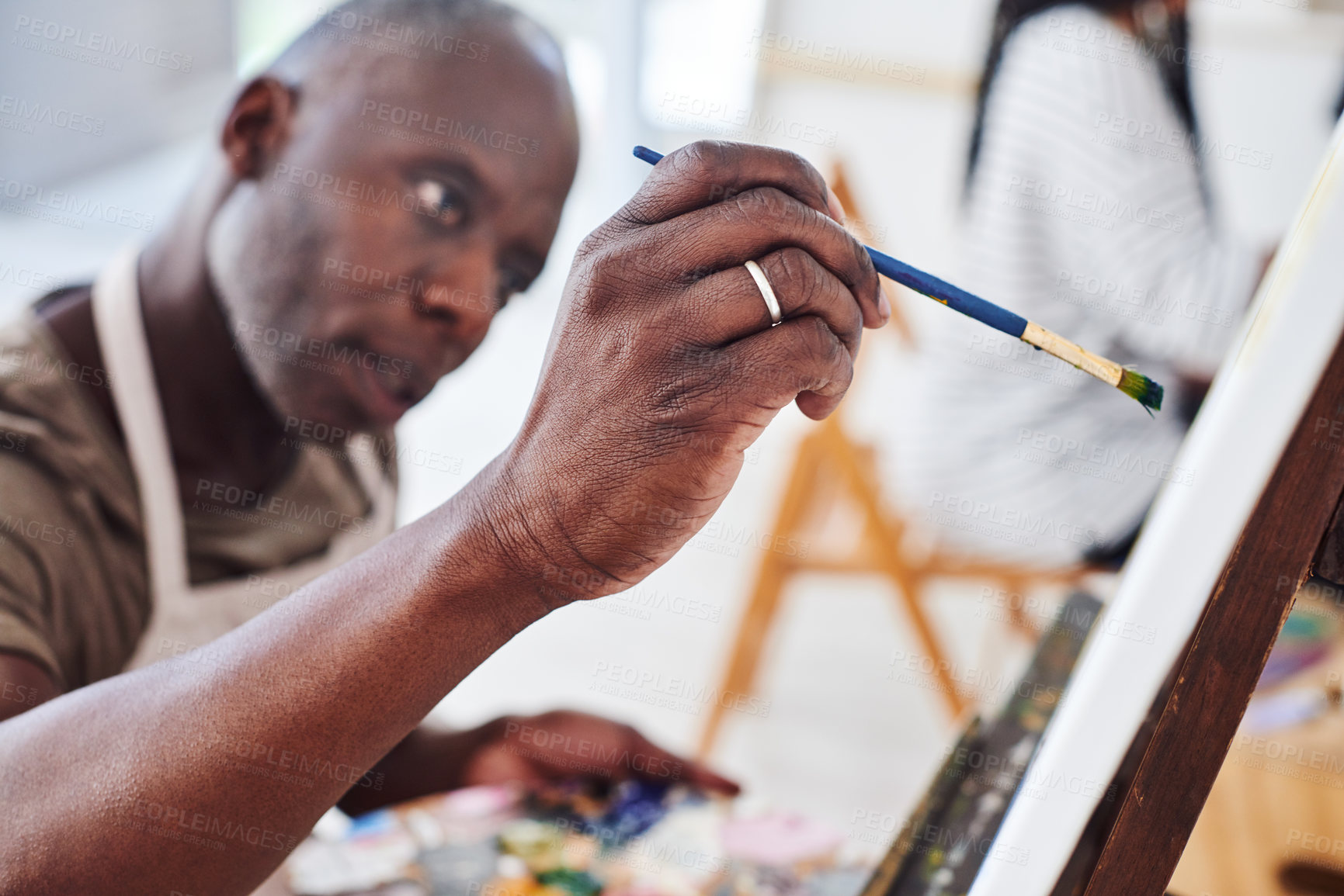 Buy stock photo Artist, mature or black man painting on canvas or easel for therapy, drawing or studio project. Creative, painter or African person with brush, class and talent for design or watercolor in workshop