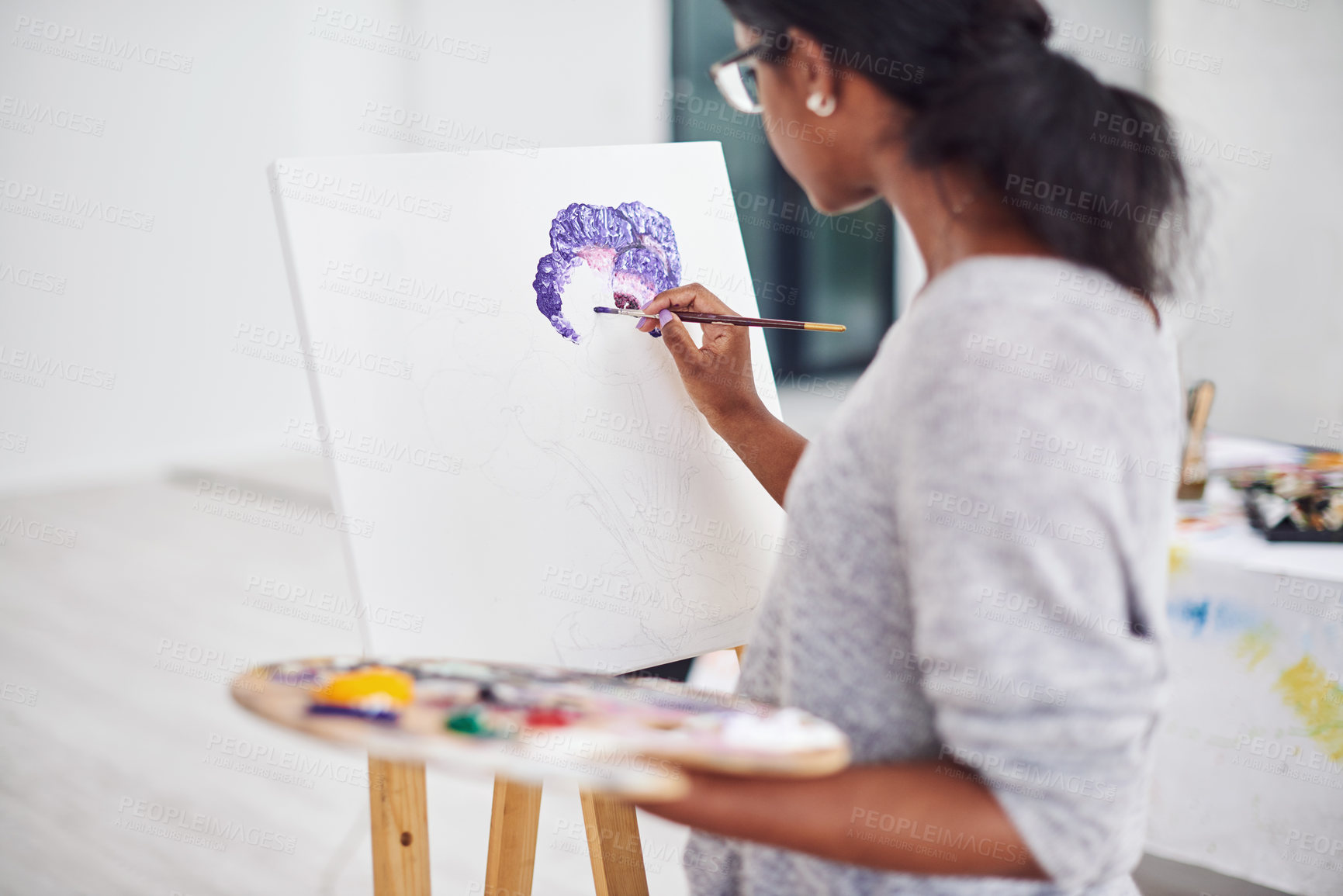 Buy stock photo Cropped shot of a beautiful young woman painting in a art studio